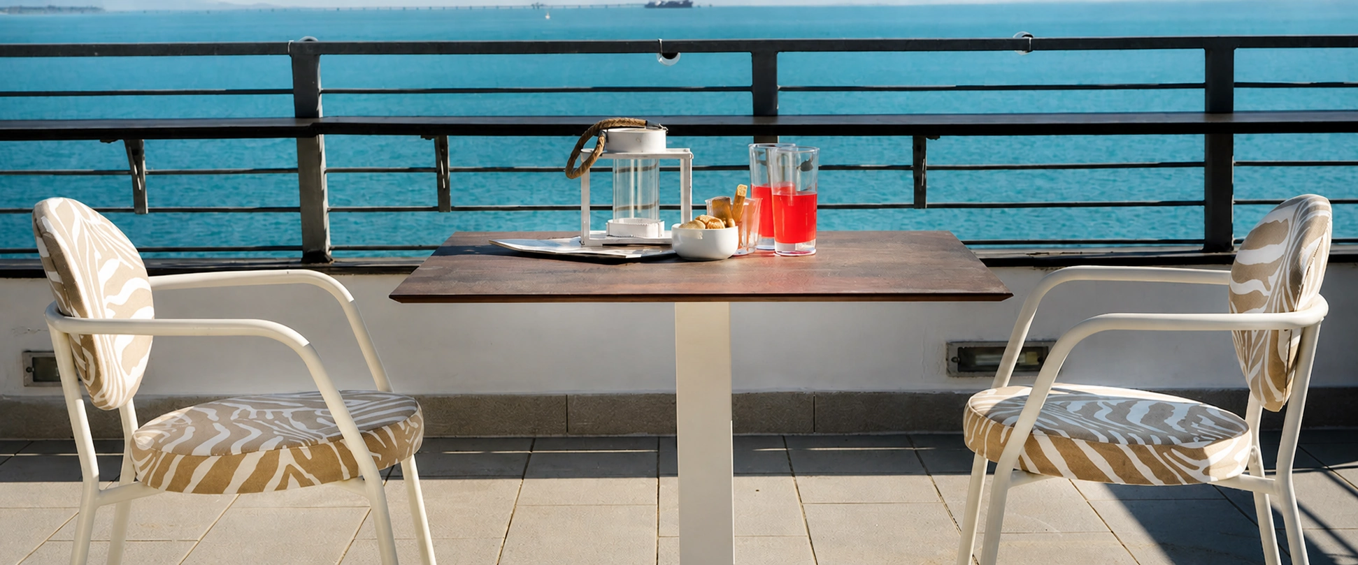 Tavolo Charleston Toscano Forme su una terrazza outdoor affacciata sul mare