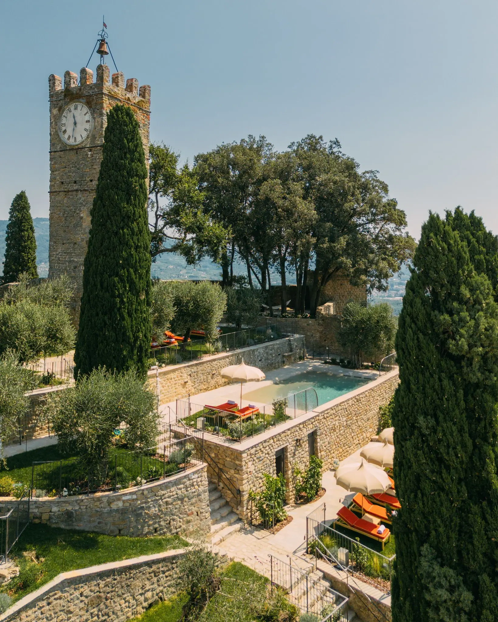 Resort toscano con torre storica, piscina, ombrelloni e lettini Toscano Forme